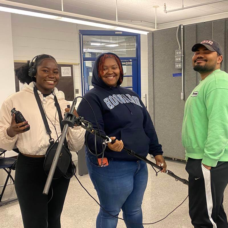 HU students holding audio equipment group photo