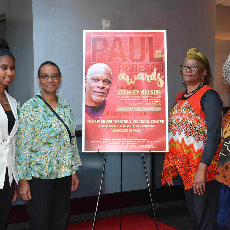 HU MJF Faculty stand with Stanley Nelson Poster at 2017 Paul Robeson Student Awards