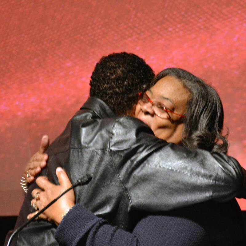 HU Faculty member hugs winner at the Paul Robeson Student Awards