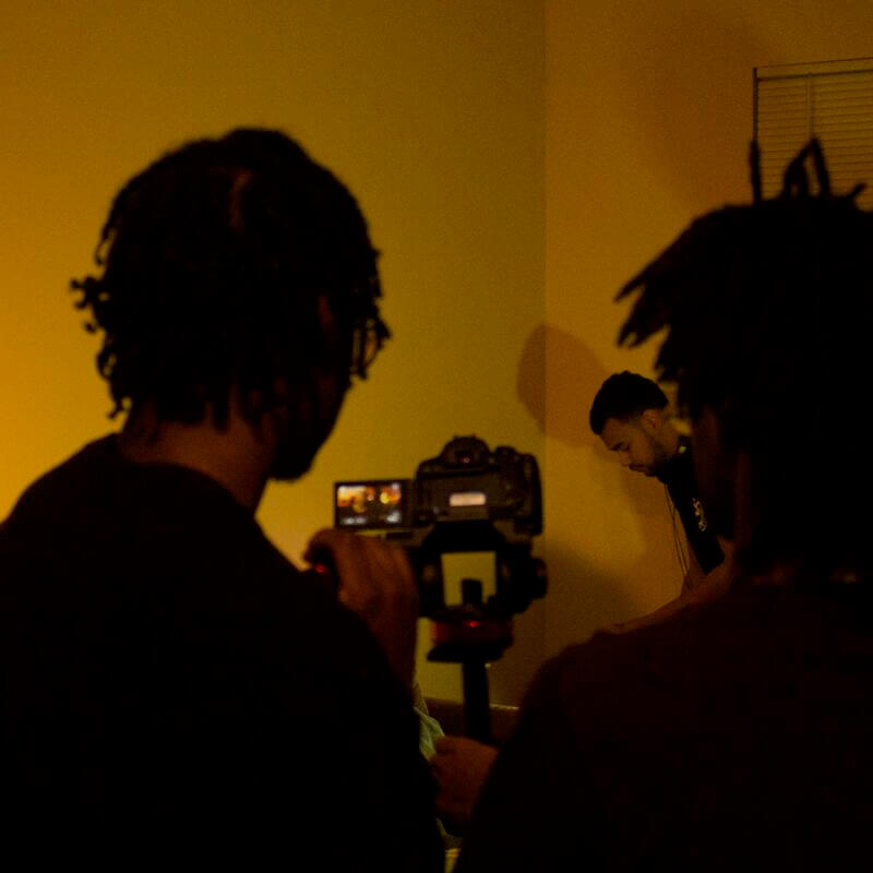 HU Students filming in yellow lighting