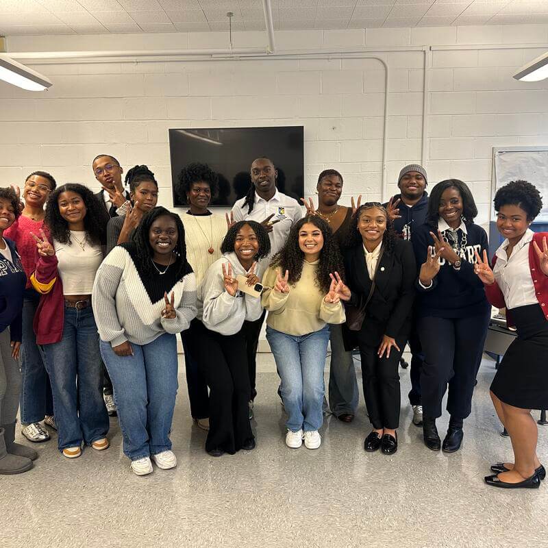 AHP Students group photo with Professor Thomas peace out 