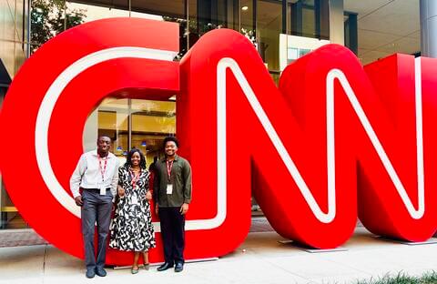 Prof. Thomas, Donovan Thomas and Kyle Fisher in front of CNN sign